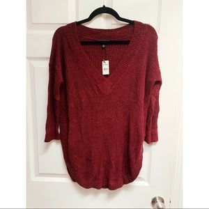 NWT. Super soft and trendy v neck sweater with high side slits. Maroon